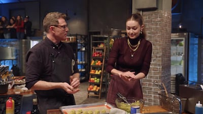 Gigi Hadid shapes falafels with chef Bobby Flay. Facebook / Food Network