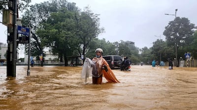 A woman wades through a flooded street in Hue, central Vietnam, after more than a metre of rain fell in 24 hours, breaking a national record set more than two decades ago. AFP