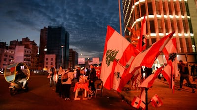 A vendor sells national flags on the Ring Bridge in Beirut. EPA