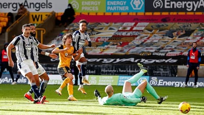 Wolves' Fabio Silva, center, fires past West Bromwich Albion goalkeeper David Button to make the score 1-1. AP