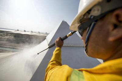 A cleaner getting rid of dust from a canopy at Yas Marina. Courtesy Seven Media