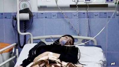 A young woman lies in hospital after reports of poisoning at an unspecified location in Iran in this still image from video from March 2, 2023. WANA/Reuters T