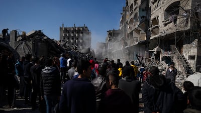 Palestinians view the destruction after an Israeli strike on residential buildings and a mosque in Rafah, in the southern Gaza Strip. AP