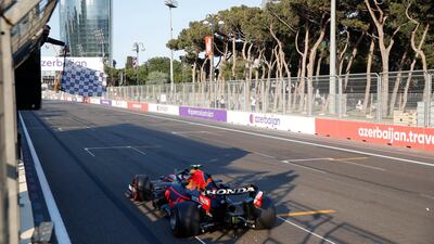 Red Bull's Sergio Perez takes the chequered flag at the Baku City Circuit. Reuters
