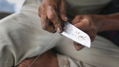 Local fisherman Rusli Suhardi prepares his lines as he heads towards fishing grounds off the east coast of Natuna Besar. As in Vietnam and the Philippines, it is Indonesia's fishing fleet that feels China's growing maritime presence most acutely. Tim Wimborne / Reuters