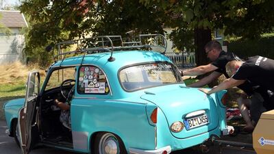 Visitors help to push start a Trabant automobile. Adam Berry / Getty Images