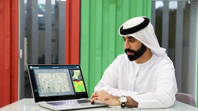 Dr Ali Al Hammadi with the crop monitoring tools he created open on his laptop at Krypto Labs in Masdar City in Abu Dhabi. Pawan Singh / The National