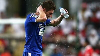 Renan Garcia soaks himself in water during a water break during the President's Cup final between Al Ahli and Al Nasr at Hazza bin Zayed Stadium on June 3, 2015 in Al Ain, UAE. (Photo by Warren Little/Getty Images)