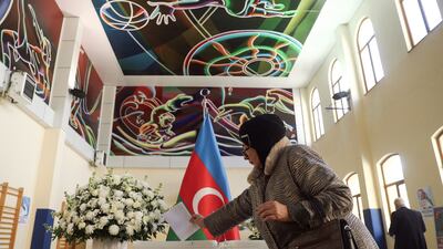 A woman votes in Baku. The two main opposition parties are boycotting the presidential election. Reuters