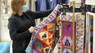 A shopper browses the colourful scarfs by Oriquo