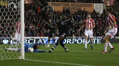 Demba Ba, centre, taps in the second goal of his hat-trick to help Newcastle United beat Stoke City 3-1.