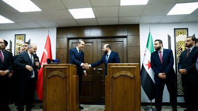 Turkey's Energy Minister Alparslan Bayraktar, left, with his Syrian counterpart Mohammed Al Bashir in Damascus. Reuters