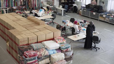 Clothes donated to charity are selected and labelled at an Emirates Red Crescent building in Mussaffah. Irene Garcia Leon / The National