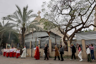 Christians march during the procession for the Palm Sunday service at the Roman Catholic Church of the Holy Family in Gaza City on March 29, 2026. AFP