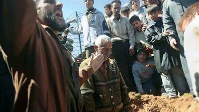 Syrians prepare to bury 13-year-old Ahmad bin Muhsin Qarush during his funeral on March 24, 2012. He was reportedly killed two days earlier in shelling by regime forces in the northwestern city of Sermin. in Syria.