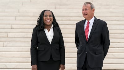 Ms Brown Jackson, seen here with Chief Justice John Roberts, is the first black woman on the US Supreme Court. AP