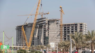 On Monday, engineers used a crane to fit a suspended bridge that connects the east and west wings of one of the hotels under construction on the island.