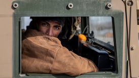 A Syrian Kurdish fighter rides in a vehicle near a frontline position in Hasakah on Saturday. Getty