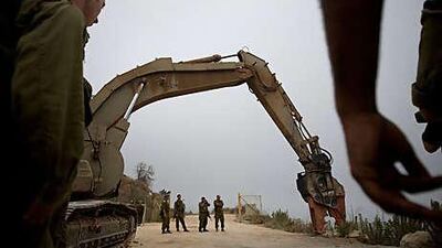 Israeli soldiers prepare to go back to the site of an exchange of fire between Israeli and Lebanese troops along the border today.