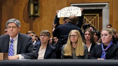 A protester is removed by police at Jack Lew's confirmation hearing. Reuters
