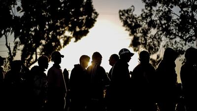 Members of the Central American migrant caravan stand in a queue at a shelter in the city of Tijuana, Baja California. EPA