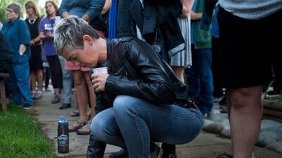 Leslie McCormick kneels down during a vigil held in Boulder, Colorado for the victims of the mass shooting at the nightclub Pulse in Orlando, Florida. Autumn Parry / Daily Camera via AP
