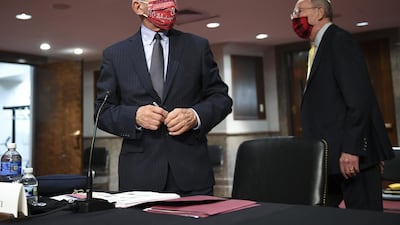 Anthony Fauci, Director of the National Institute of Allergy and Infectious Diseases, wears a Washington Nationals protective mask before a Senate Health, Education, Labor and Pensions Committee hearing in Washington this week. Bloomberg