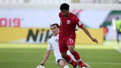 Qatar's Akram Hassan Afif shakes off a challenge from Kim Yong-Il. EPA