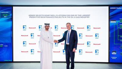 Adnoc Group chief executive Dr Sultan Al Jaber and Honeywell chairman and chief executive Darius Adamczyk shake hands following the 10 year-partnership agreement. Courtesy Adnoc Group.