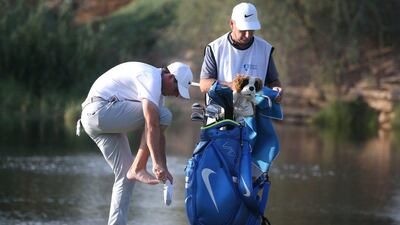 Rory McIlroy of Northern Ireland puts his shoes back on after playing his fourth shot on the 16th hole during Day 1 of the DP World Tour Championship at Jumeirah Golf Estates on November 17, 2016 in Dubai, United Arab Emirates. Francois Nel / Getty Images