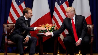 France's President Emmanuel Macron reaches out to shake hands as he holds bilateral meeting with US President Donald Trump. Reuters