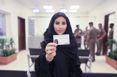 Esraa Albuti shows off her new driving licence issued by Saudi Arabia. CIC / Ministry of Media