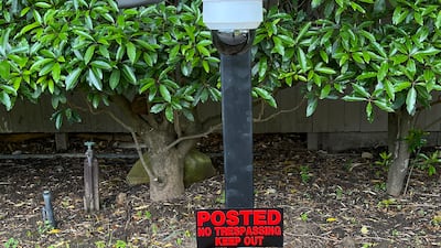 Stone walls, security cameras and no-trespassing signs further fortify the royal compound. Photo: Troy Hooper