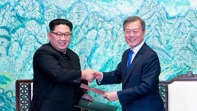 North Korean leader Kim Jong Un, left, and South Korean President Moon Jae-in shake hands after signing on a joint statement at the border village of Panmunjom in the Demilitarized Zone. Korea Summit Press Pool / via AP