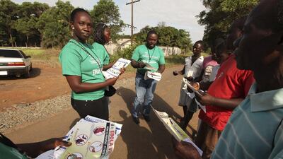 A member of the Samaritan’s Purse charity team hands out pamphlets to educate the public on the Ebola virus in Monrovia, Liberia. Reuters