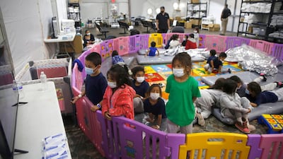 Young unaccompanied migrants, from ages 3 to 9, watch television inside a playpen at the US Customs and Border Protection centre. AP Photo