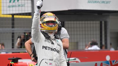 Lewis Hamilton salutes the crowd at Suzuka after claiming pole position for the Japanese Grand Prix. Toshifumi Kitamura / AFP