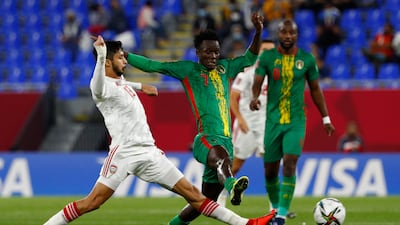 UAE defender Mohamad Al Attas, left, and Mauritania's forward Idrissa Thiam vie for the ball.