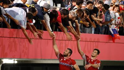 Russia's hooker Stanislav Selski, left, and winger German Davydov greet fans after the match. AFP