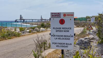 A warning sign stands at the entrance of the PDVSA/BOPEC Brasil Terminal in Rincon Bonaire on the Caribbean Netherlands island of Bonaire, where Venezuela refines and stores its heavy crude. US oil giant ConocoPhillips is pressing for control of Venezuela's key offshore operations in the Caribbean, seeking to recoup $2 billion from a decade-old dispute with the nation struggling to feed its people, a source confirmed Monday. (AP Photo/Stephan Kogelman)