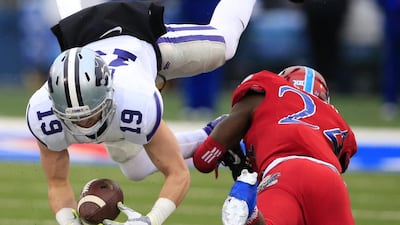 Kansas State wide receiver Kody Cook (No 19) catches a pass while being covered by Kansas safety Bazie Bates IV (No 24) on November 28, 2015, during an NCAA college football game in Lawrence, Kan. Orlin Wagner / Associated Press