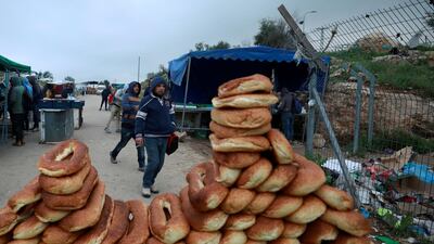 A Palestinian working in Israel heads to work with others through a border checkpoint. Reuters
