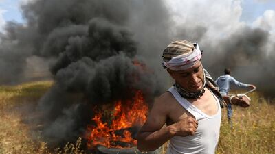 A Palestinian runs during clashes with Israeli troops. Ibraheem Abu Mustafa / Reuters