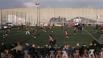 Palestinian girls and boys play football on a pitch next to Israel's separation wall in Aida Refugee Camp, in the occupied West Bank city of Bethlehem, weeks after Israeli authorities announced plans to demolish it. AP