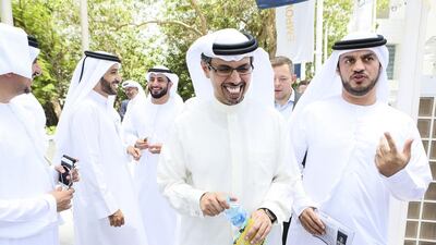 Centre, Hamad Buamim, president & CEO of Dubai Chamber of Commerce & Industry, tours various food truck concepts in the parking lot of Dubai Chamber of Commerce in Dubai. Sarah Dea / The National