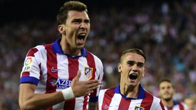 Atletico Madrid forward Mario Mandzukic, left, celebrates after scoring next to midfielder Antoine Griezmann during their win in the Supercopa de Espana on Friday night. Gerard Julien / AFP / August 22, 2014