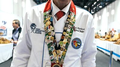 A Salon Culinaire judge wears his medals won from previous events at Gulfood.