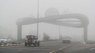 People head towards the desert on a foggy morning in Dubai. Chris Whiteoak / The National
