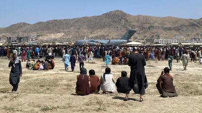 Hundreds gather near a US Air Force C-17 transport plane at the perimeter at the international airport in Kabul. AP
