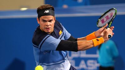 Milos Raonic slices a backhand to Stan Wawrinka during their semi-final match. Marwan Naamani / AFP